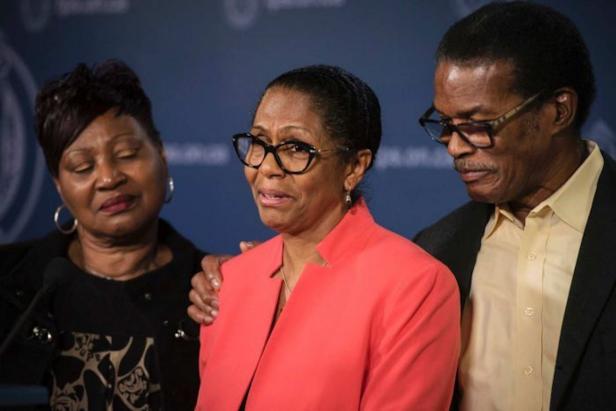 Lyneth Mann-Lewis with her family at a press conference in Toronto [Globe and Mail/ YouTube (screenshot)]