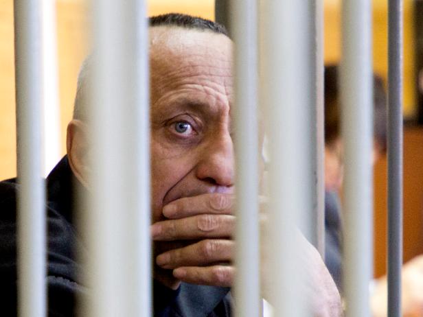Mikhail Popkov looks through bars during a court session in Irkutsk, Russia, Monday, Dec. 10, 2018 [Julia Pykhalova, Komsomolskaya Pravda via AP]