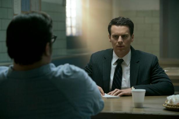 Jonathan Groff, as FBI Special Agent Holden Ford, based on John Douglas, confronts a killer across the table in Season One of the Netlix series 'Mindhunter' 