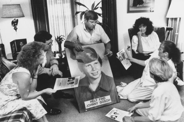 Noreen Gosch sitting next to husband, who is holding poster of their son, Johnny [Taro Yamasaki/The LIFE Images Collection via Getty Images/Getty Images]