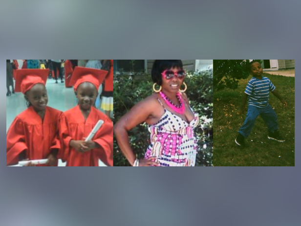 On the left, 6-year-old twins Tamiyah and Taniyah wearing red graduation gowns and caps; on the right, 3-year-old JaVonte wearing a striped shirt and jeans; and in the middle, their 27-year-old mother Brandi Peters smiling, wearing a colorful sun dress, a chunky pink necklace, gold hoop earrings, and pink framed sunglasses.