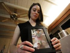 In this Feb. 13, 2017 photo, Casey Anthony poses with a photo of her daughter Caylee during an interview in her West Palm Beach, Fla., home. Anthony, 30, opens up for the first time on-the-record about the death of her daughter in 2008. (AP Photo/Joshua Replogle)