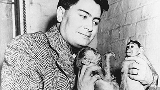 The Rev. Jim Jones poses with two monkeys he imported and sold door-to-door in Indianapolis as a fund raising project prior to founding the People’s Temple in Indianapolis in 1955. 1954 photo