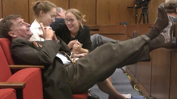 Defendant Michael Peterson sits with Margaret, center, and Martha Ratliff, daughters of Elizabeth Ratliff, after the jury began deliberations in Peterson's murder trial Monday, Oct. 6, 2003, in Durham, N.C. Peterson is accused of killing his wife, Kathleen Peterson. Elizabeth Ratliff, a school teacher at an American military base in Germany, was found dead in 1985 after being seen with Peterson the previous night. Michael Peterson cared for her daughters after her death. (AP Photo/Pool, Chuck Liddy)