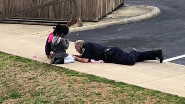 Police Officer C.B. Fleming playing with dolls [WKTR video/screenshot]