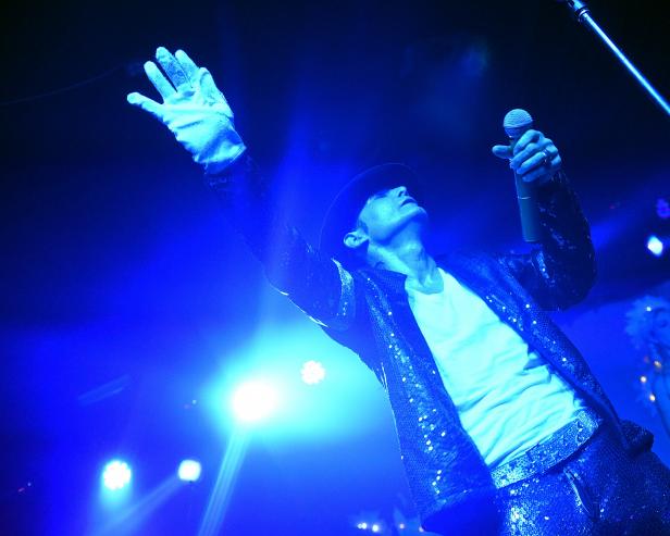 Corey Feldman performing at Michael Jackson tribute wearing a glove and hat given to him by Jackson [Chris McKay/Getty Images]