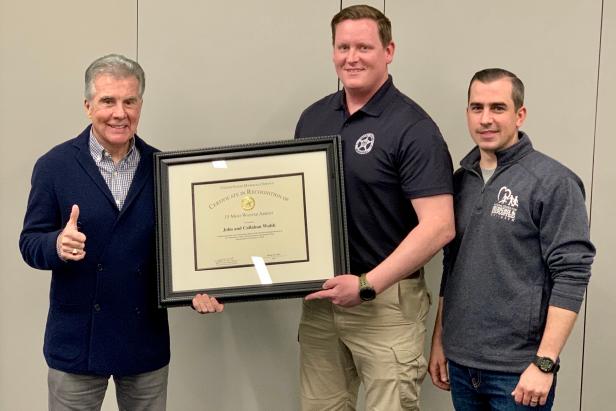 John & Callahan Walsh presented with capture certificate by US Marshal [Michelle Sigona]