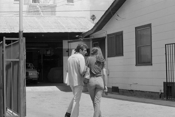 Angelo Buono talks to a girl in front of his upholstery shop as a press conference was being held in downtown Los Angeles announcing that Bianchi will be charged with the murder of 10 of 13 "Hillside Strangler" victims [Bettmann/Getty Images]