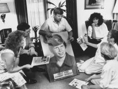 Noreen Gosch sitting next to husband, who is holding poster w.picture of their son, & w. other members of Johnny Gosch Foundation, effort formed to locate boy who disappeared when he was 12-years-old & is assumed to have been kidnapped, meeting.  (Photo by Taro Yamasaki/The LIFE Images Collection via Getty Images/Getty Images)