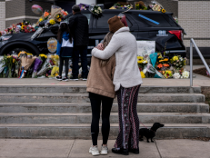 People paying their respects to victims killed after a gunman open fire in a supermarket in Boulder, Colorado [via Getty Images]
