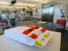 A rape kit that has been examined and sealed lies on a desk at the LAPD's crime lab at the Hertzberg-Davis Forensic Science Center in Los Angeles. [via Getty Images]