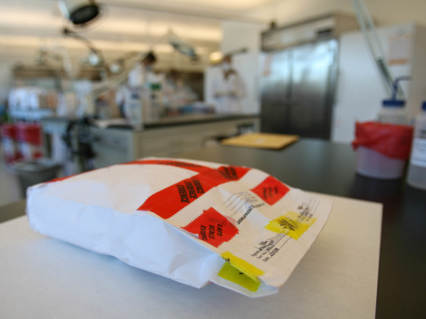 A rape kit that has been examined and sealed lies on a desk at the LAPD's crime lab at the Hertzberg-Davis Forensic Science Center in Los Angeles. [via Getty Images]