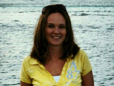 photo of young woman Michelle O'Connell wearing a yellow shirt standing in front of the ocean