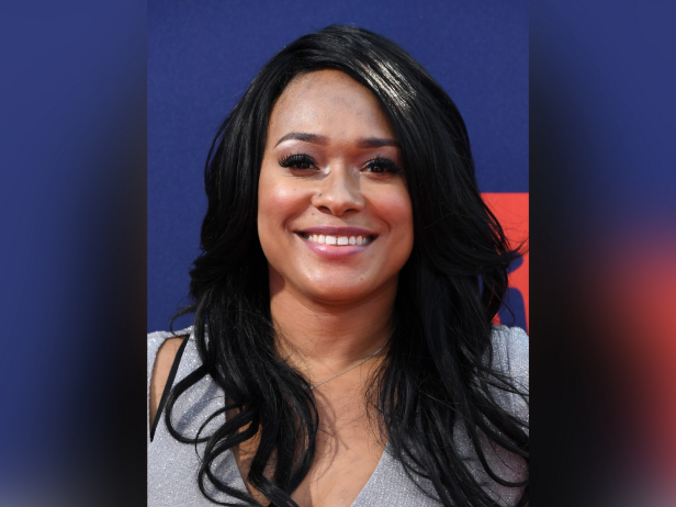 A photo of Lisa VanAllen. She has long black hair and is wearing a silver dress.