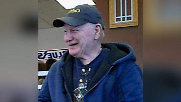 A photo of Phiiip Snider who is a white male. He is pictured with a baseball cap and a blue hooded jacket.