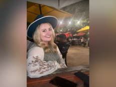 Ciaya Whetstone is a young woman with blonde hair. In this photo she is wearing a top with white sleeves and a black wide-brimmed hat