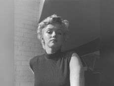 Portrait of American actor Marilyn Monroe circa 1955 posing in front of a brick wall, wearing a sleeveless sweater. 