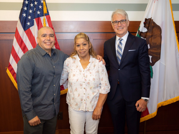 Alexander Torres (l) pictured with his mother and LA District Attorney George Gascon. Alex was exonerated in the 2000 murder of Martin Guitron.