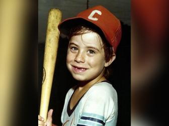 Adam Walsh, pictured here smiling holding a baseball hat, was six years old when he went missing from a Hollywood, Florida mall. 