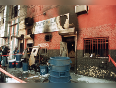 The charred facade of the Happy Land social club in the Bronx section of New York City is pictured in 1990. 