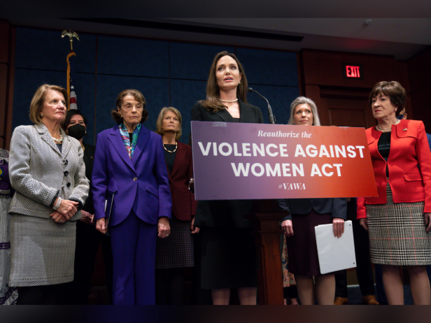 Actress and activist Angelina Jolie, center, is joined by multiple female senators at a news conference to announce a bipartisan update to the Violence Against Women Act, at the Capitol in Washington, Wednesday, Feb. 9, 2022.