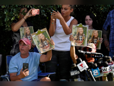 In this Wednesday, Oct. 20, 2021, file photo, Supporters of Gabby Petito hold up photos of Gabby after a news conference Wednesday, Oct. 20, 2021, in North Port, Fla.