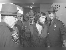 In this Nov. 15, 1974 file photo, Ronald DeFeo Jr., center, leaves Suffolk County district court after a hearing, on New York's Long Island.