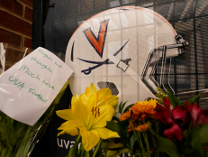 Memorial flowers and notes line walkway at Scott Stadium after three football players were killed in a shooting on the grounds of the University of Virginia Tuesday Nov. 15, 2022, in Charlottesville. Va.