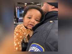 5-month-old Kason Thomas being held by Indianapolis Metropolitan Police Department officer on Dec. 22, 2022.