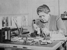 A photo of Frances Glessner Lee working on creating her miniature crime scenes.